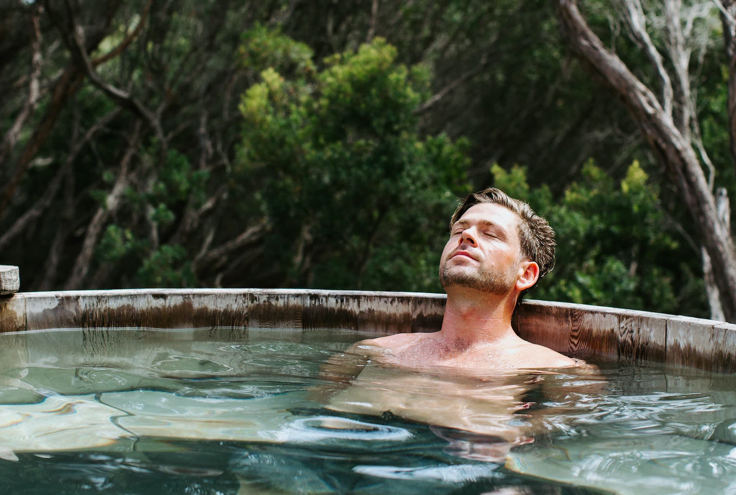Man relaxes in Peninsula Hot Springs pool. 