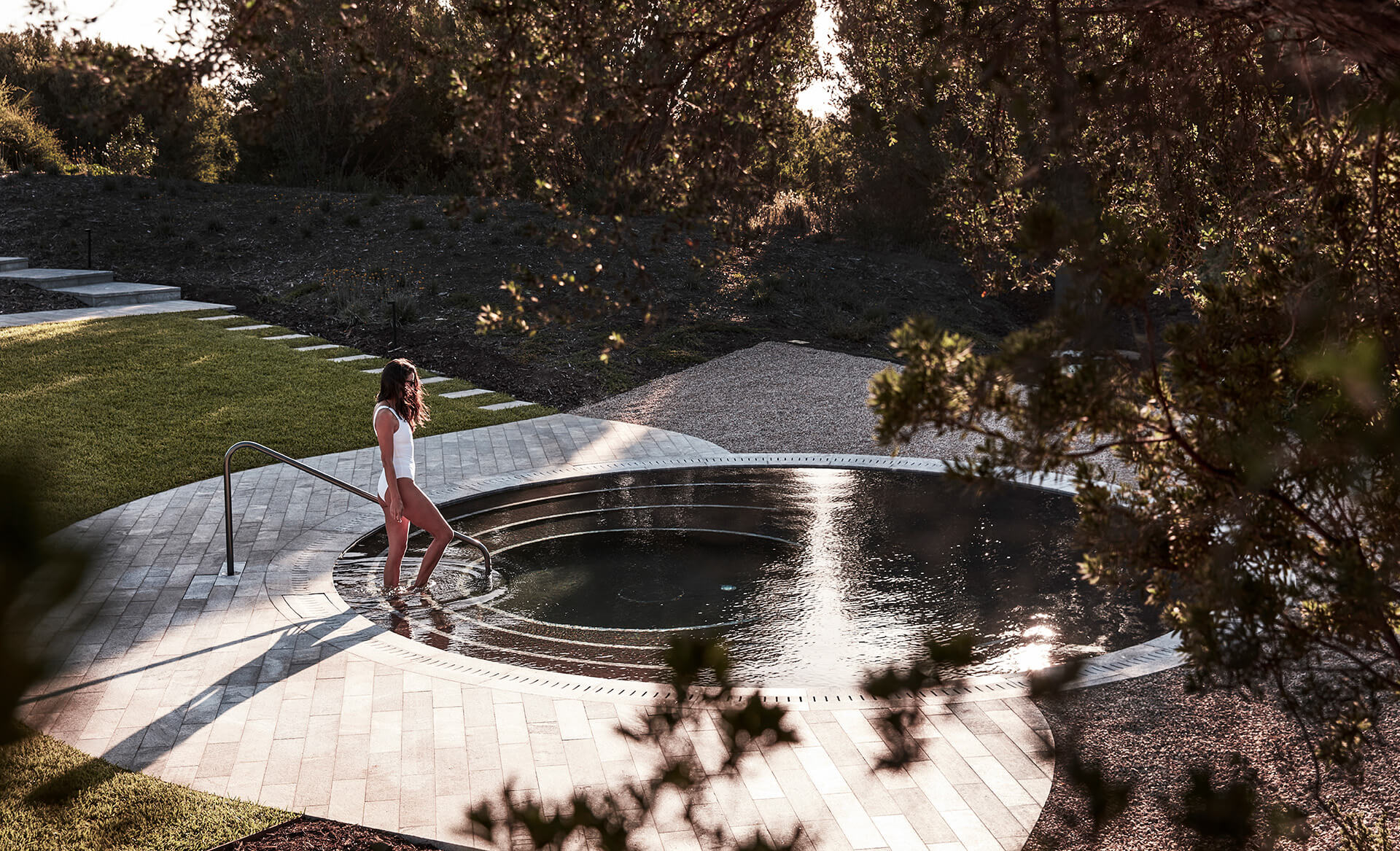 A lady walks into one of the pools at Alba thermal springs. 